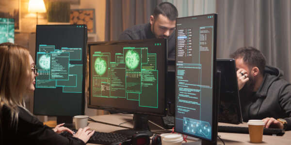 Female hacker with her team of cyber terrorists making a dangerous virus to attack the government.